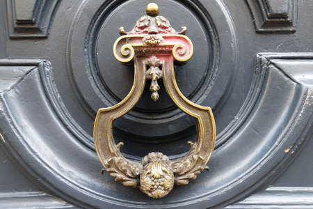 European Vintage old metal wrought iron door knocker. Design detail. Paris.の写真素材