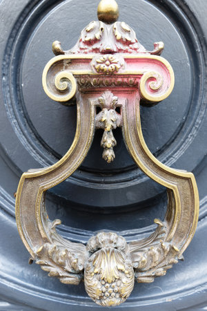 European Vintage old metal wrought iron door knocker. Design detail. Paris.の写真素材