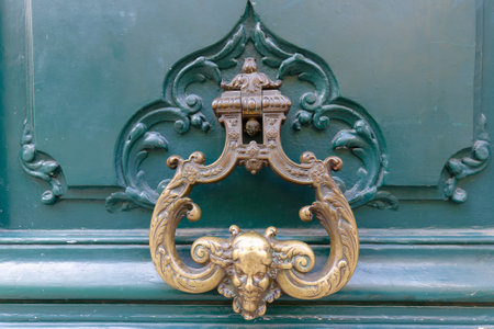 European Vintage old metal wrought iron door knocker. Design detail. Paris.の写真素材