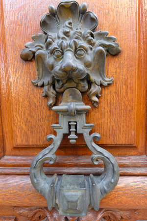 European Vintage old metal wrought iron door knocker. Design detail. Paris.の写真素材