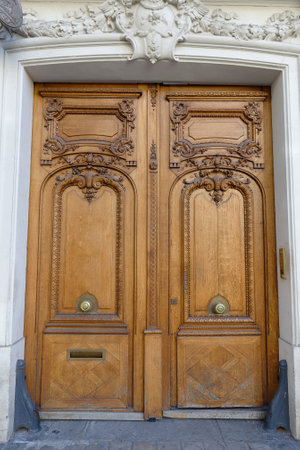 Old ornate door in Paris - typical old apartment buildiing.の写真素材