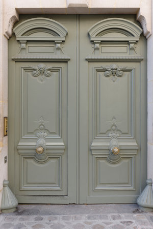 Old ornate door in Paris - typical old apartment buildiing.の写真素材