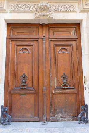Old ornate door in Paris - typical old apartment buildiing.の写真素材