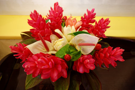 Colorful tropical flowers bouquet arrangement on wooden background.の写真素材