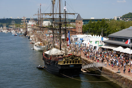 Armada gathering of tall ships on the Seine river, crowds of visitors walk on the dock and visit the shipsのeditorial素材