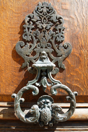 European Vintage old metal wrought iron door knocker. Design detail. Paris.の写真素材