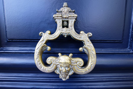 European Vintage old metal wrought iron door knocker. Design detail. Paris.の写真素材