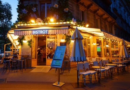Typical Parisian cafe Marguerite at night located next town hall of Paris, France.のeditorial素材