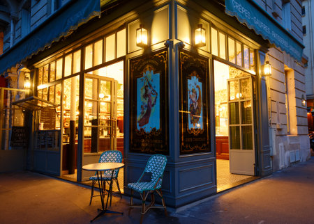 Typical Parisian pastry shop and cafe La Dame de Paris at night located next to famous Notre Dame cathedral Paris, France.のeditorial素材