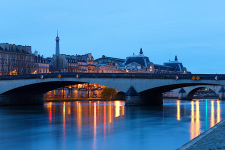 Night view of the banks of the Seine in Paris, France, with Carrousel bridge , Ouai Voltaire and...