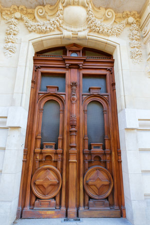 Old ornate door in Paris, France - typical old apartment building.の写真素材