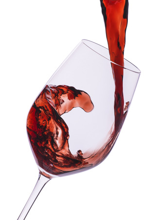 Red wine pouring into the glassの写真素材