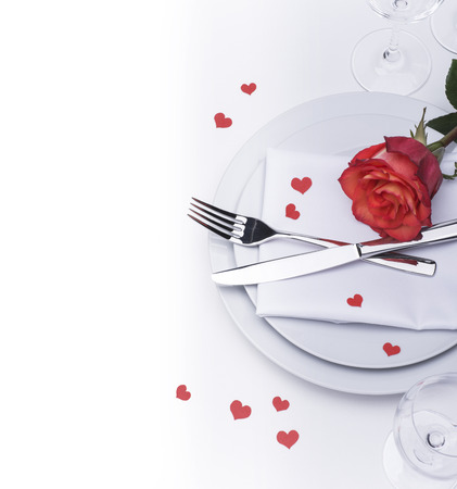 Festive restaurant table set for Valentines with rose and heartsの写真素材