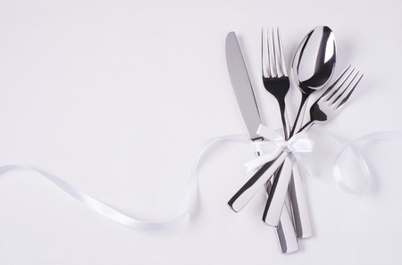 Glossy silverware on white background