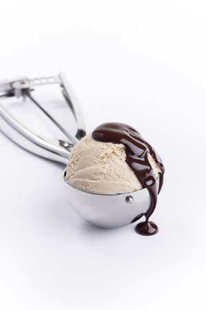 Vanilla creme brulee ice cream scoop with chocolate on top isolatedの写真素材