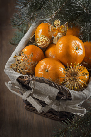 Basket of mandarins and fur tree for new yearの写真素材