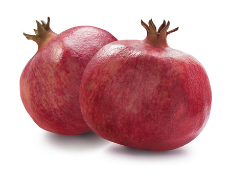 Two whole pomegranates isolatedの写真素材