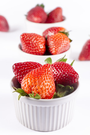 Fresh berries in ceramic bowls isolatedの写真素材