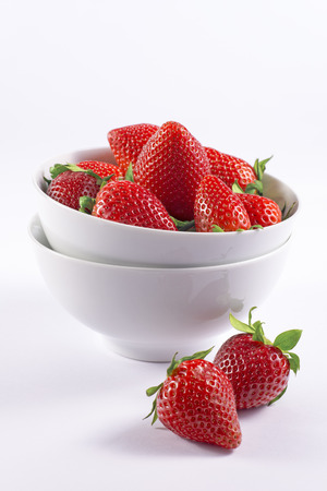Red berries in bowl isolated for menu and invitationの写真素材