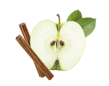 Green apple half cut with cinnamon sticks isolated on white background as package design elementの写真素材