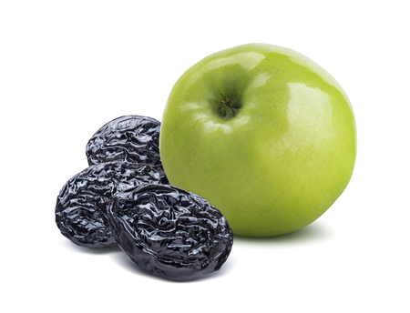 Whole green apple back and dry plums isolated on white background as package design elementの写真素材