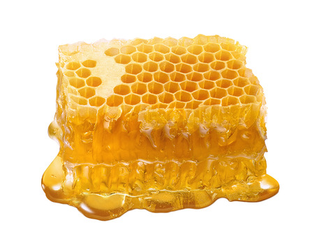 Honeycomb single piece. Honey slice isolated on white background with clipping pathの写真素材