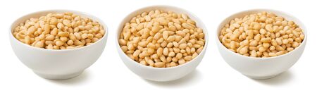 Pine nuts in bowls isolated on whiteの写真素材