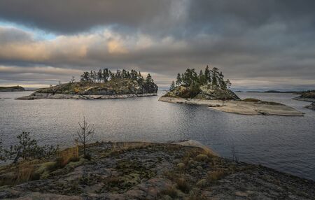 Two islands covered in forest. Nordic landscape. Scenic view. Horizontal layout for travel materianlsの写真素材