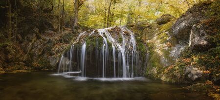 Beautiful waterfall in the autumn forest. Scenic view. October timeの写真素材