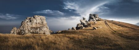 Mountain top with beautiful rocks and visible vehicle tracks. Dramatic sky. Crimea, Demerjiの写真素材