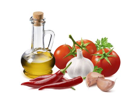 Italian pesto ingredients, tomato, garlic, onion, chili pepper  and olive oil in bottle isolated on whiteの写真素材