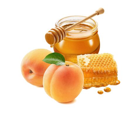 Fresh apricots and honey jar with honeycomb isolated on whiteの写真素材