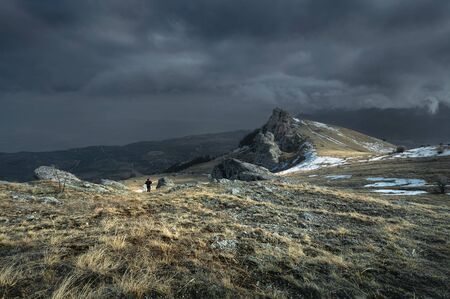 Hiker goes up the mountain.の写真素材