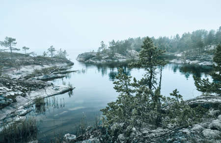 Morning fog over a rocky shore. Ladoga lake. Scenic viewの写真素材