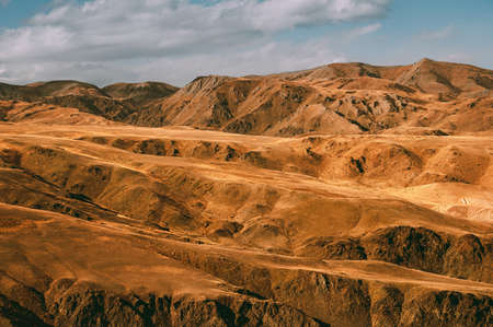 Yellow fold mountains under blue sky. Altai landscape. Scenic viewの写真素材