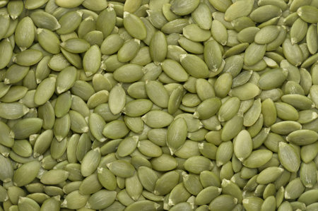 Green pumpkin seeds background. top view. flat lay. Texture element for packaging and marketing materials designの写真素材