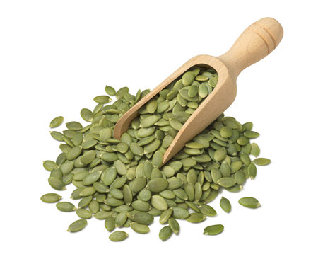 Green pumpkin seeds in wooden scoop isolated on white background. side view. package design element with clipping pathjの写真素材