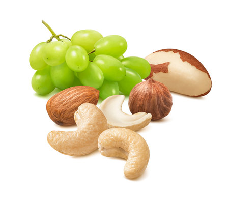 Green grapes, cashew, almond, hazelnut and brazil nuts isolated on white background. For square layouts. Package design element with clipping pathの写真素材