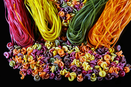 Set of different kinds of colorful Italian pasta, on a black background, healthy food concept, close-up.の写真素材