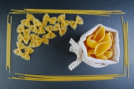 Different kinds of pasta, background of food ingredients, image of the concept of advertising in a restaurant or market, place to copy text, set.の写真素材