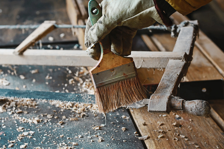 brush process from gunpowder and web, wood planer and shavings at carpenters workshop, old woodworking tool, sawdust, antique saws.の写真素材