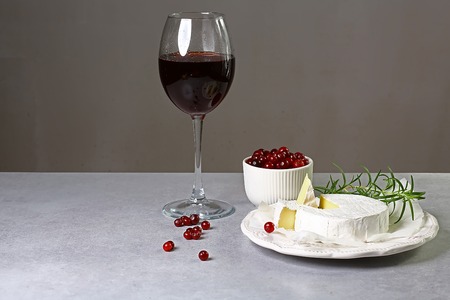 Camembert cheese, cranberry with red wine, twig of rosemary, Top side view, selective focus, close up. set.の写真素材