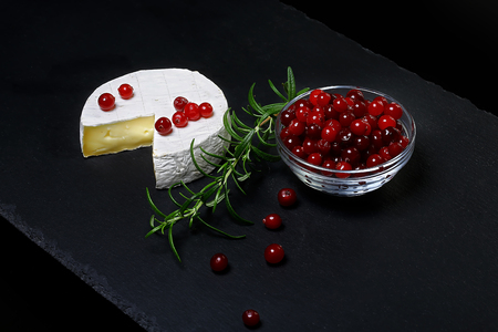 Cheese Camembert Cranberry Rosemary Isolated on a dark stone board, copy space. set.の写真素材
