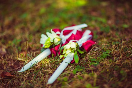 wedding candles with natural environment decorated ribbons and flowers, on the grass, selective focus.の写真素材