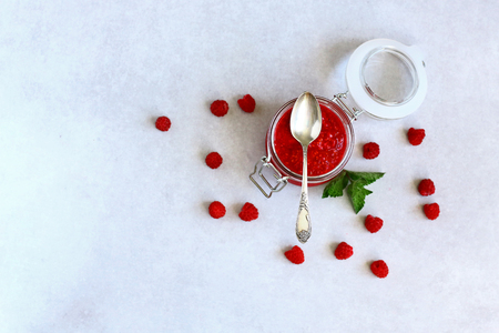 Flat lay composition with delicious raspberry jam on grey background.の写真素材
