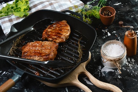grilled beef fillet steaks with herbs and spices on dark background. Food concept.の写真素材
