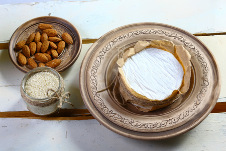 Round white cheese tasting on wooden background . top view image with copy space, set.の写真素材
