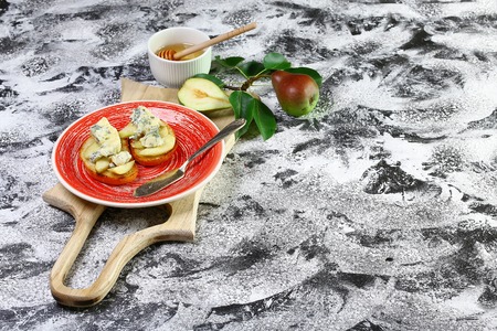Cooking bruschetta with pears, apple, cheese and honey. Food recipe background. Flat lay. copy text.の写真素材
