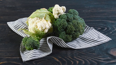 Delicious broccoli and cauliflower has a wooden rustic table. Authentic lifestyle image. Top view with copy space.の写真素材