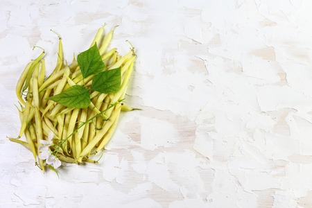 fresh yellow bean pods with leaves on a light background, food closeup, Copy Space for Text. Website Banner Poster Template. Vegetarian Supefoods.の写真素材